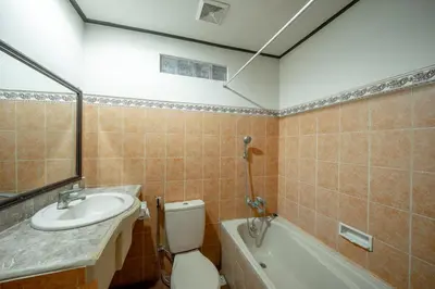 a bathroom with a toilet and a sink and a tub at Bendesa Accommodation in Kuta