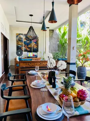 a dining room with a table with food on it at CASA PINARAK 1 I 3BR Private Villa near Seminyak in Seminyak