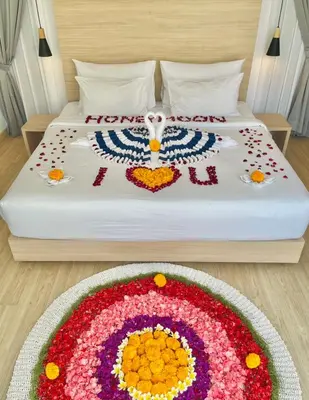 a bed with a flower arrangement on it at Alami Luxury Villa in Seminyak