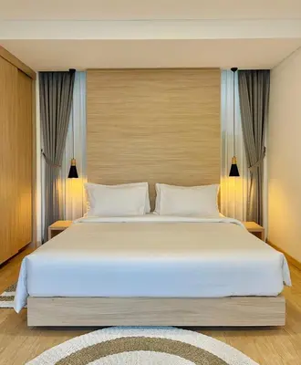 a bedroom with a large bed with white pillows at Alami Luxury Villa in Seminyak