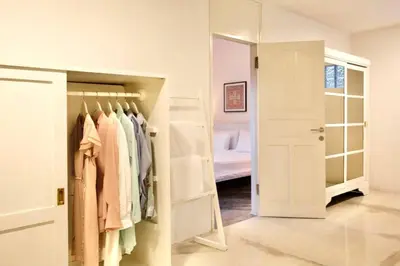 a dressing room with a closet and a bed at Villa Lola in Seminyak