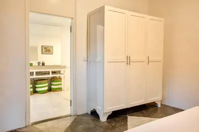 a white cabinet in a room with a hallway at Villa Lola in Seminyak