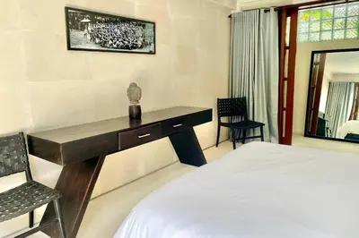 a bedroom with a desk and a bed and a chair at Villa Lola in Seminyak