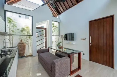 a home office with a glass desk and a chair at PANDAWA VILLAS SEMINYAK in Seminyak