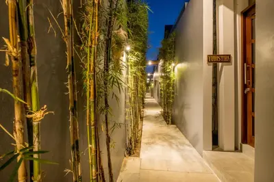 an alley with plants on the side of a building at PANDAWA VILLAS SEMINYAK in Seminyak