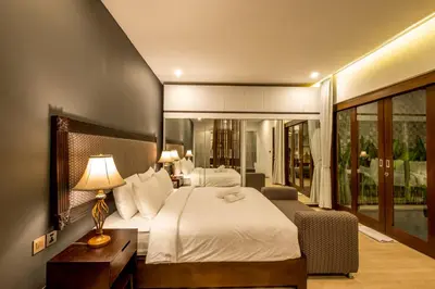 a hotel room with a bed and a desk with a lamp at PANDAWA VILLAS SEMINYAK in Seminyak