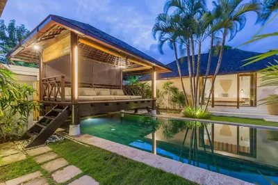 a house with a swimming pool and a pergola at Villa B in Seminyak