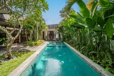 a swimming pool in the backyard of a villa at Villa Hatari Canggu in Kerobokan