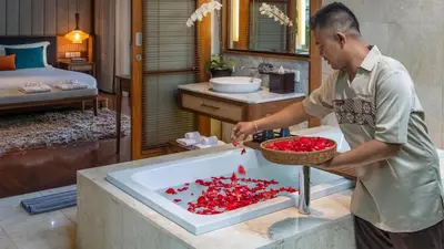 a man preparing food in a sink in a room at Villa Windu Sari in Seminyak
