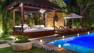 a gazebo with a bed and a pool at Villa Windu Sari in Seminyak