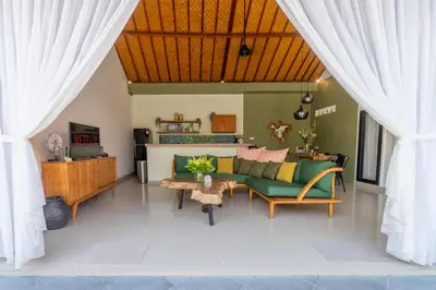 a living room with a couch and a table at CASTELU 3BR peacefully villa near Mertanadi in Seminyak
