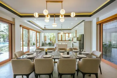 a dining room with a table and chairs at Villa Reillo Canggu in Canggu