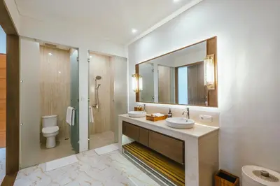a bathroom with two sinks and a mirror at Villa Reillo Canggu in Canggu