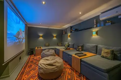 a living room with a couch and a flat screen tv at Villa Bull House Amazing 6 bedrooms contemporary villa in Seminyak in Seminyak