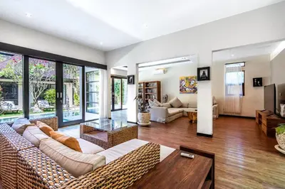 a living room with a couch and a table at Anedda Merta Sari Villa Sanur in Sanur