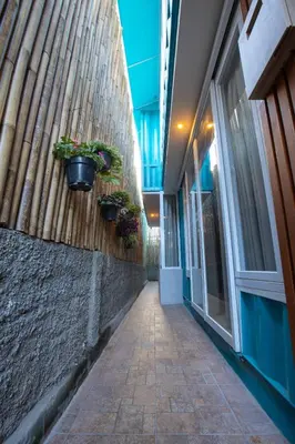 a hallway with potted plants on the side of a building at Lacrissa Bali in Kerobokan