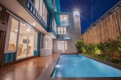 a swimming pool in the middle of a building at Lacrissa Bali in Kerobokan