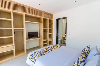 a bedroom with wooden shelves and a bed at Villa Lys by Alfred in Bali in Canggu