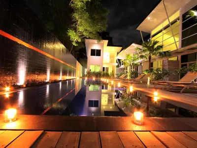 a view of a pool at night with lights at Bali Yarra Villas - Seminyak in Seminyak