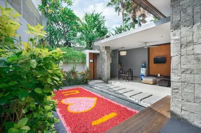 a garden with a red rug with a design on it at Samaja Villas Seminyak in Seminyak