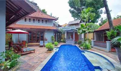 a swimming pool in the backyard of a house at Villa Naga Maya in Legian