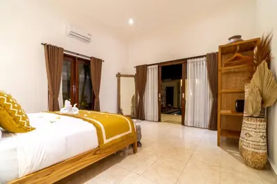 a bedroom with a bed and a large window at CASA MALEH 2BR lively villa in kayuaya seminyak in Seminyak