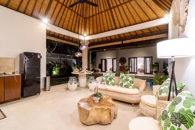 a living room with couches and a table at CASA MALEH 2BR lively villa in kayuaya seminyak in Seminyak