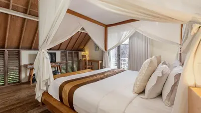 a bedroom with a bed with a canopy at Casa Mateo Villa in Seminyak