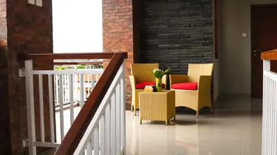 a stairway with chairs and a table and a staircase at Kubu De Uma in Seminyak