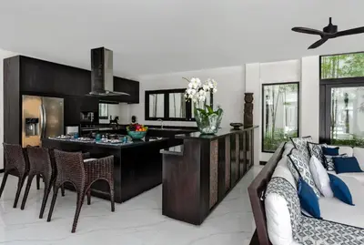 a kitchen with a table and chairs in a room at Villa Anaya Manis in Seminyak