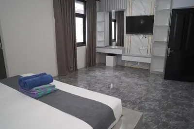 a bedroom with a bed and a flat screen tv at 4 BEDROOM VILLA KUTA REGENCY B10 in Kuta