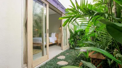 a room with a door leading to a bedroom at Sari Alexa Villas in Seminyak