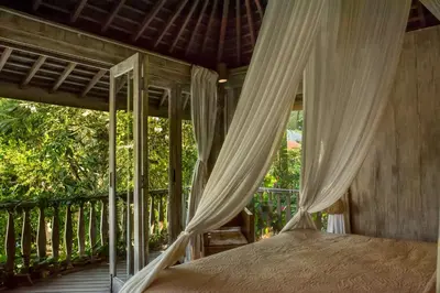 a bedroom with a canopy bed on a porch at Villa Istimewa in Seminyak