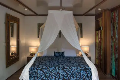 a bedroom with a bed with a canopy at Villa Istimewa in Seminyak