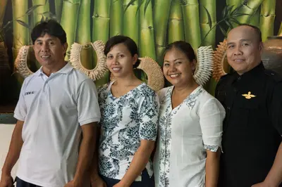 a group of people posing for a picture in front of bamboo at Villa Istimewa in Seminyak