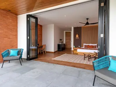 an open living room with a couch and a bed at Villa Castil di Udara by Villa Finder in Kerobokan