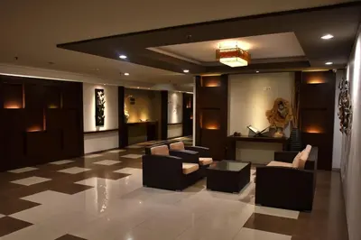 a lobby with couches and a teddy bear on the wall at The Kana Kuta Hotel in Kuta