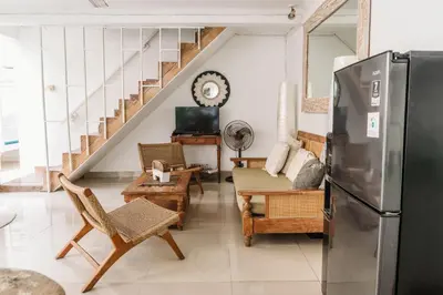 a living room with a refrigerator and a table and chairs at Mara Villa, Garden & Pool, 2 min to Seminyak Beach in Seminyak