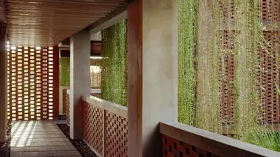 a hallway with green plants on the wall at Amnaya Resort Nusa Dua in Nusa Dua
