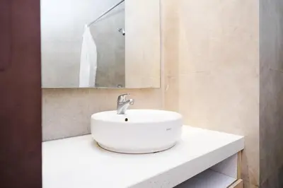 a bathroom with a white sink and a mirror at Lega Legi Town House Seminyak by The Lavana in Seminyak