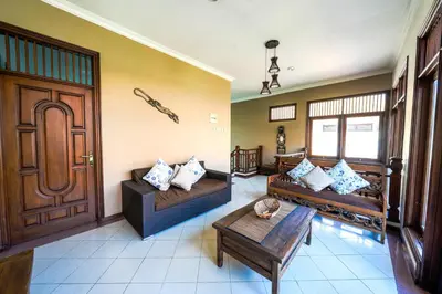 a living room with two couches and a table at Villa SANKET - KUTA - 6 bedrooms - 6 bathrooms - Great Location in Kuta