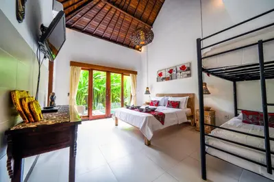 a bedroom with two bunk beds and a television at Villa CRIS - Heart of LEGIAN 3 Bedrooms, 3 Bathrooms in Legian