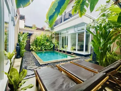 a courtyard with a swimming pool in a house at OASIS 66 Villa - Heart of Legian/Seminyak - Double Six in Seminyak