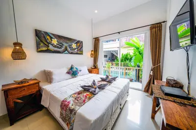 a bedroom with a bed and a tv and a window at OASIS 66 Villa - Heart of Legian/Seminyak - Double Six in Seminyak