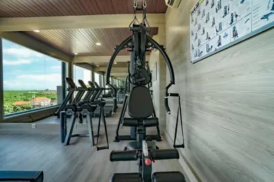 a gym with a row of exercise bikes in a room at Sunrise Aventus Hotel Nusa Dua in Nusa Dua