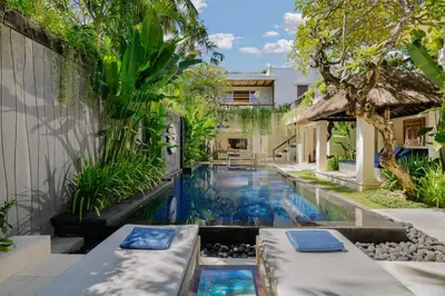 a swimming pool in the backyard of a house at Jimbaran Bay Villas by Nakula in Jimbaran