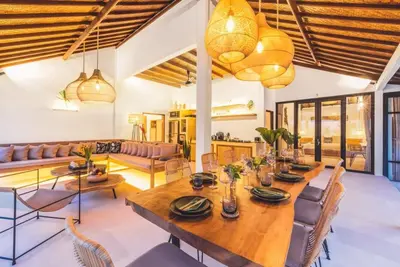 a dining room with a large wooden table and chairs at Villa Baladeva - 5 BDR Luxury Villa with huge private Pool in Kuta