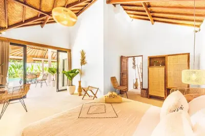a bedroom with a large bed and a patio at Villa Baladeva - 5 BDR Luxury Villa with huge private Pool in Kuta