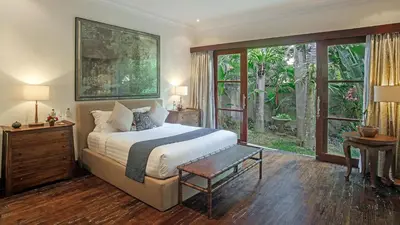 a bedroom with a bed and a large window at Villa Avalon by Elite Havens in Canggu