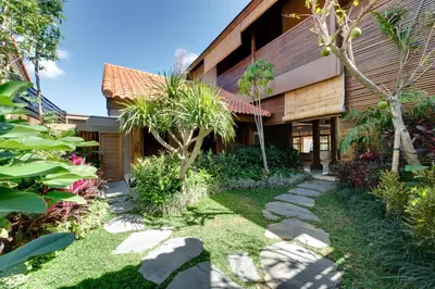 a garden in front of a building at Villa Kinaree Estate in Seminyak